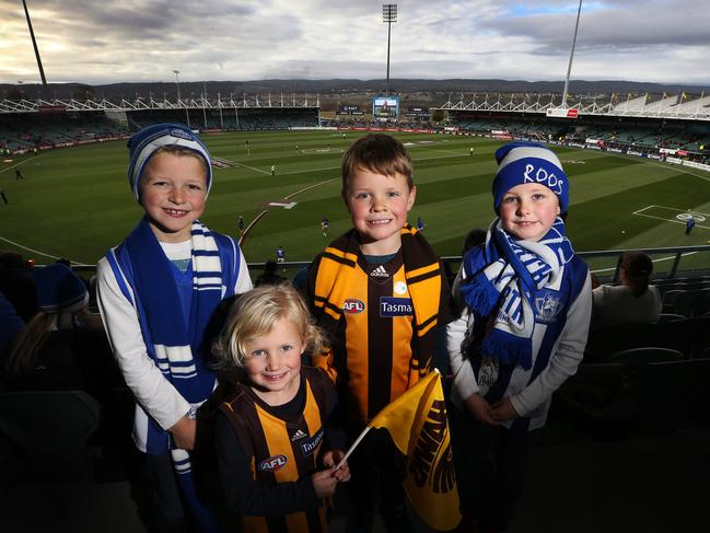 North Melbourne supporters Tyler, 8, left, and Makayla Rigby, 5, right, of Launceston and Hawthorn supporters Chloe, 4, and Sam Geason, 7, of Hobart at the AFL at UTAS Stadium. Picture: CHRIS KIDD