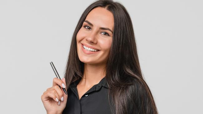 Smiling confident caucasian young businesswoman auditor writing on clipboard, signing contract document isolated in white background; checklist generic