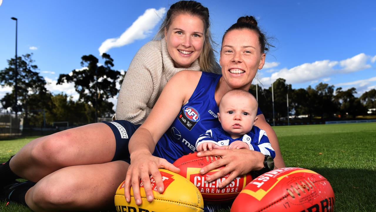 North Melbourne AFLW player Britt Gibson is all smiles with her partner Jaime and baby, five-month-old Henry. Picture: Tony Gough