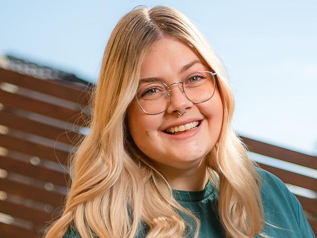 Dana Thomson, 25, (with pet bird Atticus) says she had a "quarter life crisis" when she first finished university three years ago - unsure which direction she wanted her career to take. At home in Melbournes south eastern suburbs. Picture: Jason Edwards