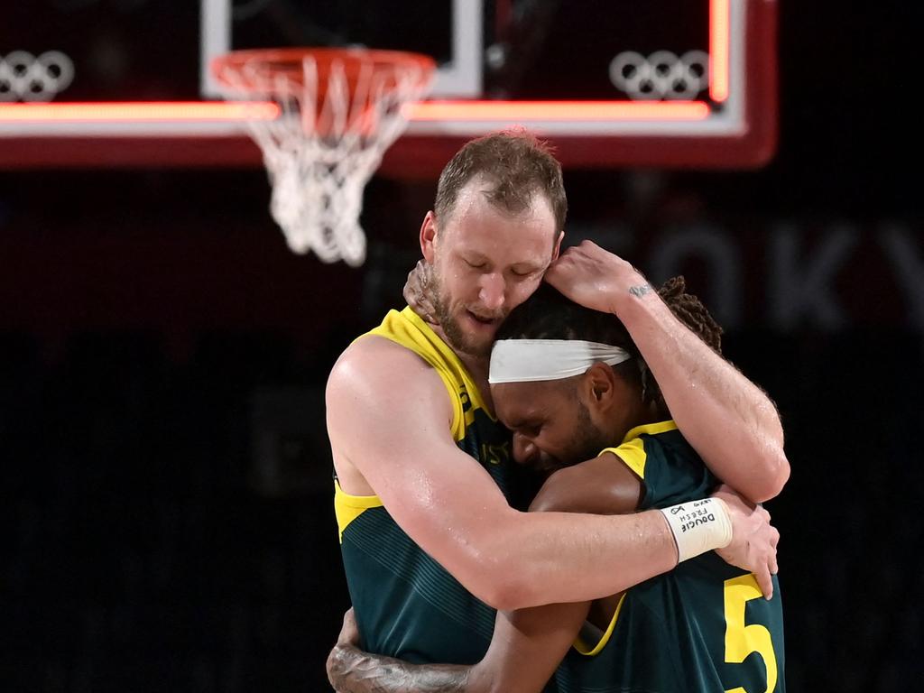 Aussie stars Joe Ingles and Patty Mills embrace.