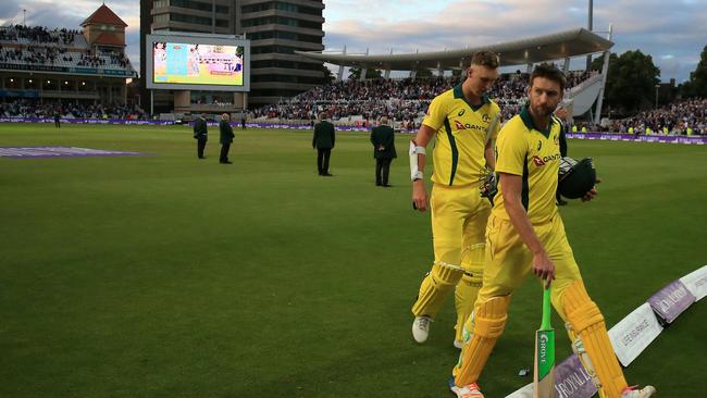 Billy Stanlake and Andrew Tye leave the field after the Aussies’ massive loss. Pic: AFP