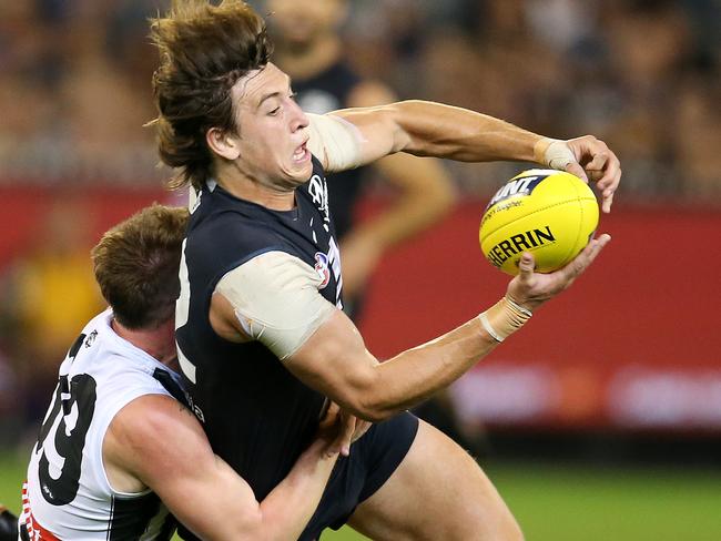 AFL Round 3. Carlton v Collingwood at the MCG. Carlton's Caleb Marchbank tackled by Collingwood's Ben Crocker  . Pic: Michael Klein