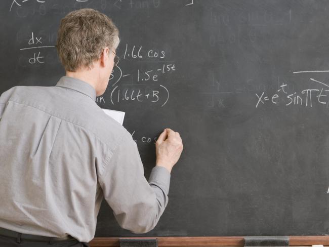 High School Teacher Writing Equation on Chalkboard