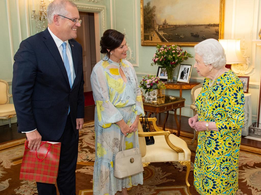 Britain's Queen Elizabeth II (R) greets Australia's Prime Minister Scott Morrison (L), and his wife Jenny, during an audience at Buckingham Palace in 2019.