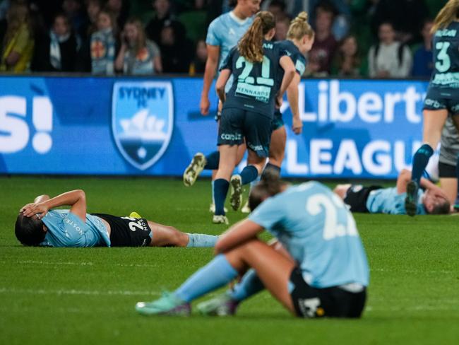 MELBOURNE, AUSTRALIA - MAY 04: Dejected Melbourne City players react on the ground as Sydney FC players celebrate after winning the A-League Women Grand Final match between Melbourne City and Sydney FC at AAMI Park, on May 04, 2024, in Melbourne, Australia. (Photo by Asanka Ratnayake/Getty Images for A-Leagues)