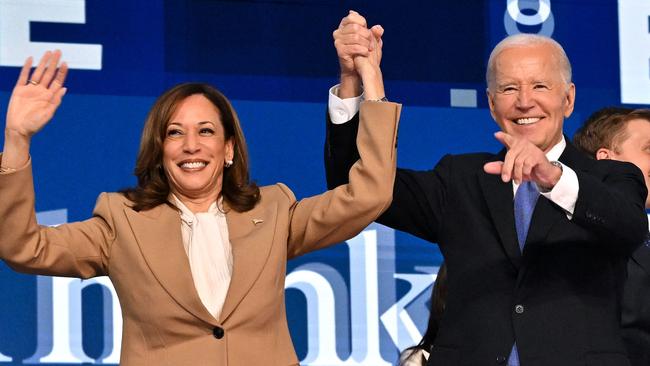 (FILES) US President Joe Biden holds US Vice President and 2024 Democratic presidential candidate Kamala Harris hand after delivering the keynote address on the first day of the Democratic National Convention (DNC) at the United Center in Chicago, Illinois, on August 19, 2024. Kamala Harris and Donald Trump are entering the final one-month sprint to the most dramatic US presidential election in modern history, with both candidates warning the fate of a divided nation hangs on a result that is still too close to call. (Photo by Robyn Beck / AFP)