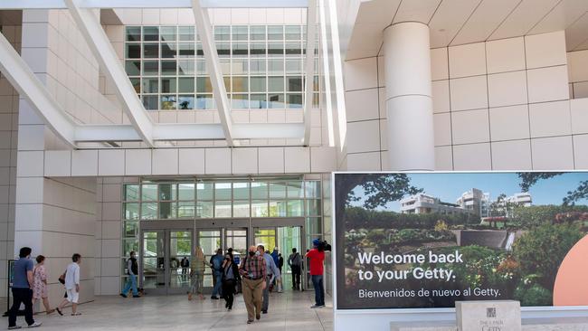 The first visitors arrive at the Getty Museum in Los Angeles on its reopening day on May 25. California officials announced the state is on track to remove physical distancing guidelines and fully reopen its economy beginning on June 15. Picture: Valerie Macon