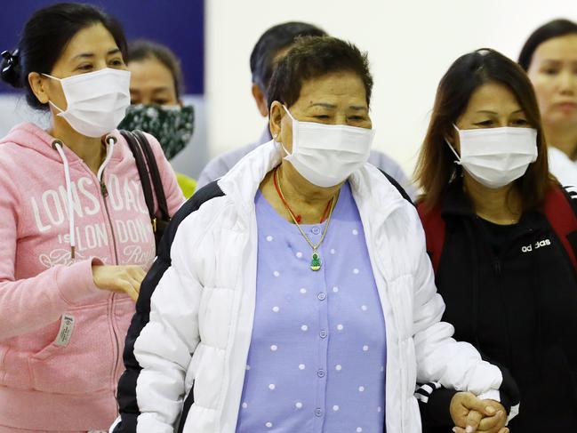 People wear masks through an airport. Picture: Matrix