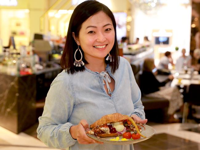 Primrose Cafe co-owner Karlina Widjaja with the cafe’s soft shell crab croissant. Picture: Angelo Velardo