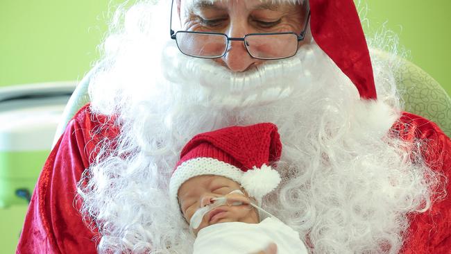 Joan Kirner Womens and Childrens Hospital Christmas prem baby stories.  PJ NG is held by Santa during Santas rounds of the ward in HDU section of Newborn Services.BoyParents Vanessa and Paz NgDOB: 19/10/24Gestation: 27 weeks, 1 dayBirth weight: 740g                                                            Picture: David Caird