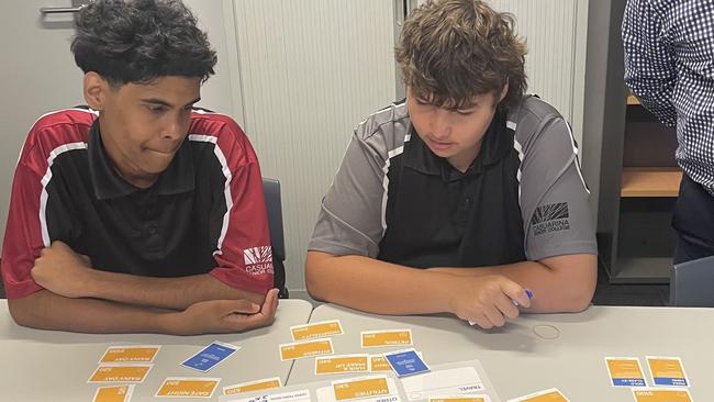 Casuarina Senior College and Clontarf Foundation students Nathaniel and Jack learn to 'budget like a boss' with the help of Bank of Queensland Qld and NSW state manager Ross Gillam.