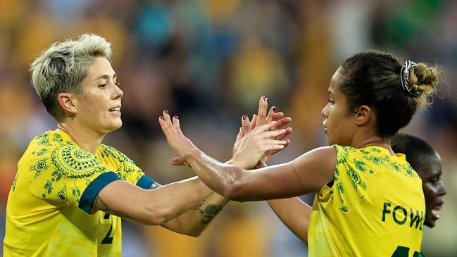 Australia's forward #02 Michelle Heyman celebrates scoring her team's sixth goal with Australia's forward #11 Mary Fowler in the women's group B football match between Australia and Zambia during the Paris 2024 Olympic Games at the Nice Stadium in Nice on July 28, 2024. (Photo by Valery HACHE / AFP)