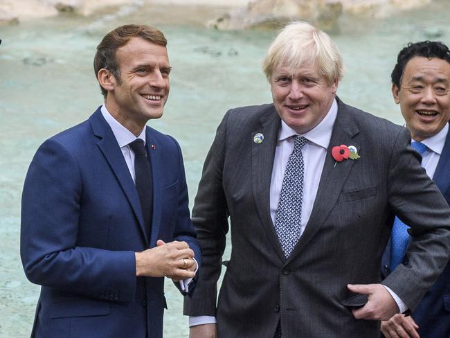 ROME, ITALY - OCTOBER 31: (L-R) French president Emmanuel Macron, British Prime Minister Boris Johnson, Director general, Food and Agriculture Organization (FAO), Qu Dongyu visit the Trevi fountain on the second day of the Rome G20 Summit, on October 31, 2021 in Rome, Italy. The G20 (or Group of Twenty) is an intergovernmental forum comprising 19 countries plus the European Union. It was founded in 1999 in response to several world economic crises. Italy currently holds the Presidency of the G20 and this year's summit will focus on three broad, interconnected pillars of action: People, Planet, Prosperity. (Photo by Antonio Masiello/Getty Images) *** BESTPIX ***