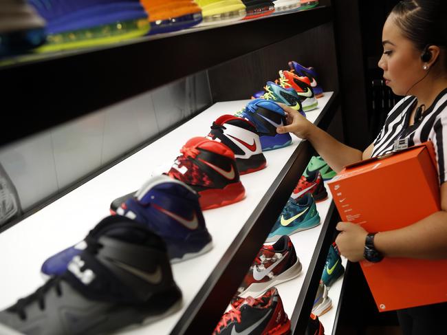 A salesperson arranges Nike basketball shoes on display at the House Of Hoops by Foot Locker retail store at the Beverly Center in Los Angeles, California, U.S., on Wednesday, Aug. 21, 2013. Foot Locker Inc. is expected to announce second-quarter earnings results on Aug. 23. Photographer: Patrick T. Fallon/Bloomberg