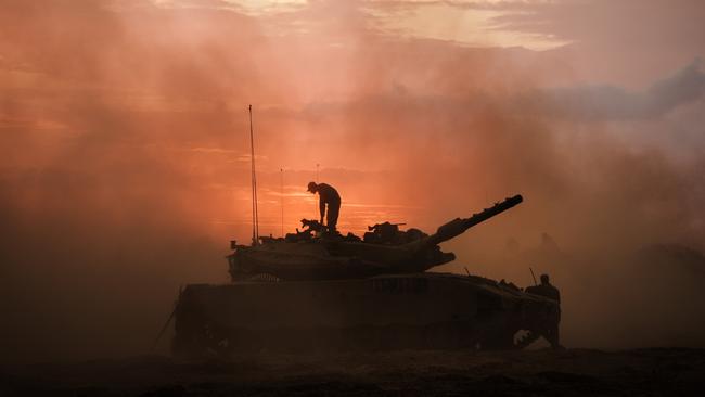 Israeli Merkava battle tank units regroup near the border of Gaza, in the southern part of Israel.