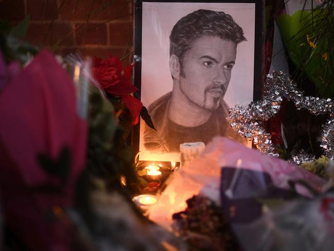 Flowers and tributes are left outside the Oxfordshire home of British pop singer George Michael. Picture: Carl Court/Getty Images