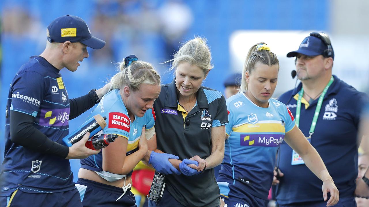 GOLD COAST, AUSTRALIA – AUGUST 19: Emily Bass of Titans is assisted out of the ground after suffering an injury during the round five NRLW match between Gold Coast Titans and Sydney Roosters at Cbus Super Stadium, on August 19, 2023, in Gold Coast, Australia. (Photo by Getty Images/Getty Images)