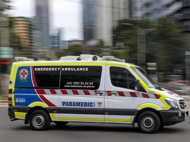 MELBOURNE, AUSTRALIA - NewsWire Photos FEBRUARY 13, 2022: An ambulance speeds away from the Royal Melbourne Hospital. Ambulance, Generic.Picture: NCA NewsWire / David Geraghty