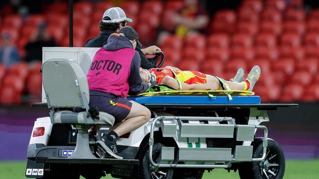 Barwick was then stretchered off the ground, before getting up and walking around the rooms. Picture: Russell Freeman/AFL Photos