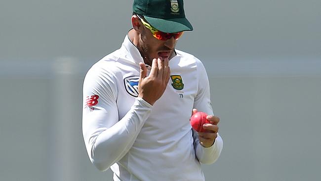 South African captain Faf du Plessis takes saliva to shine the ball. (AAP Image/Dave Hunt)