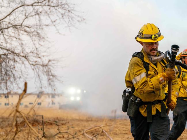 Firefighters works to contain the Hughes Fire as it draws nearer to a neighbourhood. Picture: AFP