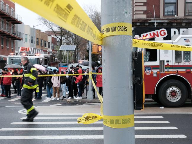 NEW YORK, NEW YORK - APRIL 12: Police and emergency responders gather at the site of a reported shooting of multiple people outside of the 36 St subway station on April 12, 2022 in the Brooklyn borough of New York City. According to authorities, multiple people have reportedly been shot and several undetonated devices were discovered at the 36th Street and Fourth Avenue station in the Sunset Park neighborhood.   Spencer Platt/Getty Images/AFP == FOR NEWSPAPERS, INTERNET, TELCOS & TELEVISION USE ONLY ==