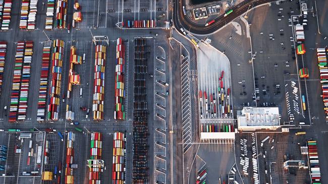 Shipping containers and trucks at the Port of Los Angeles. West Coast dock workers and cargo companies are starting contract talks this week. Picture: AFP