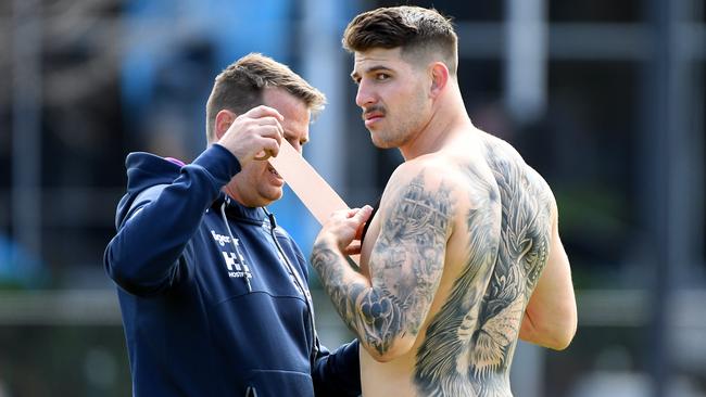 Curtis Scott (right) of the Melbourne Storm is seen during a training session at the Holden Centre in Melbourne, Tuesday, September 24, 2019. The Storm take on the Roosters this Saturday in the NRL Preliminary final. (AAP Image/James Ross) NO ARCHIVING