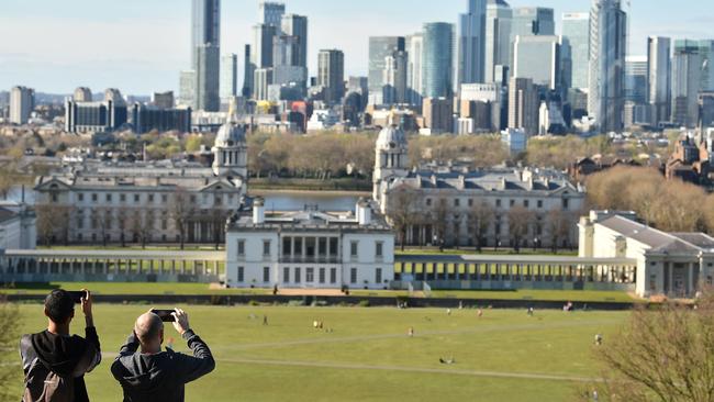 People take their daily exercise in a deserted Greenwich Park in south London. Picture; AFP.