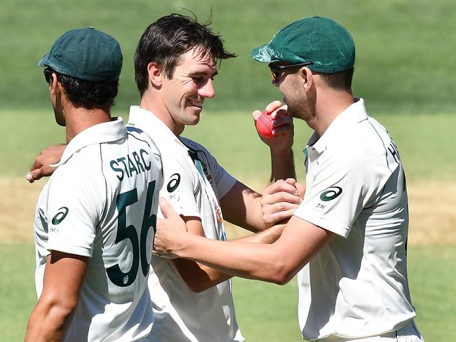 Pat Cummins hands the ball to Josh Hazlewood after they bowled India out for 36. Picture: Getty Images