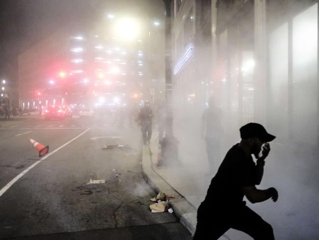 A protester scrambles to escape a cloud of tear gas in Detroit, Michigan. Picture: Getty Images/AFP