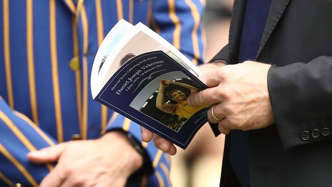 A mourner reads the Order of Service. Picture: Getty Images