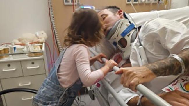 Josie with her father Mark Peebles in Royal North Shore Hospital after he survived a horrific car crash on May 9, 2025. Picture: Supplied