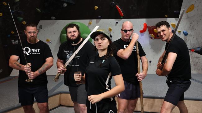 Cairns filmmakers and actors have begun filming local production Quest: A Hero Within. Movie hero Elleni Geena Adams (front) with orcs Robert Bryant, Chris Ghensi, Beau Strickland and Boyd Robertson begin weapons training at Defy Gravity gym and training centre. Picture: Brendan Radke