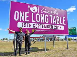 SIGN OF WHAT'S TO COME: CCCI staff Justin Fox and Gaye Smith celebrate the launch of their billboard for the One Long Table event. Picture: Madison Watt