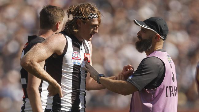 Nathan Murphy of the Magpies leaves the field with trainers. Photo by Daniel Pockett/AFL Photos/via Getty Images.