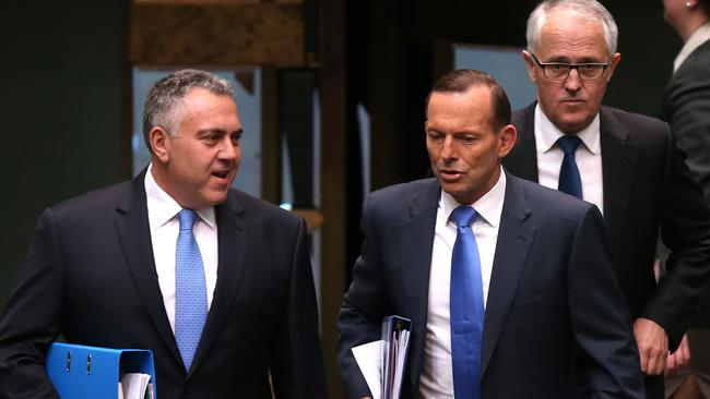 Treasurer Joe Hockey, PM Tony Abbott and Malcolm Turnbull arrive for Question Time in the House of Representatives Chamber, Parliament House in Canberra.
