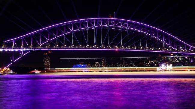 The Sydney Harbour Bridge is illuminated purple on Thursday night to mark The Queen's Platinum Jubilee. Picture: Getty Images)