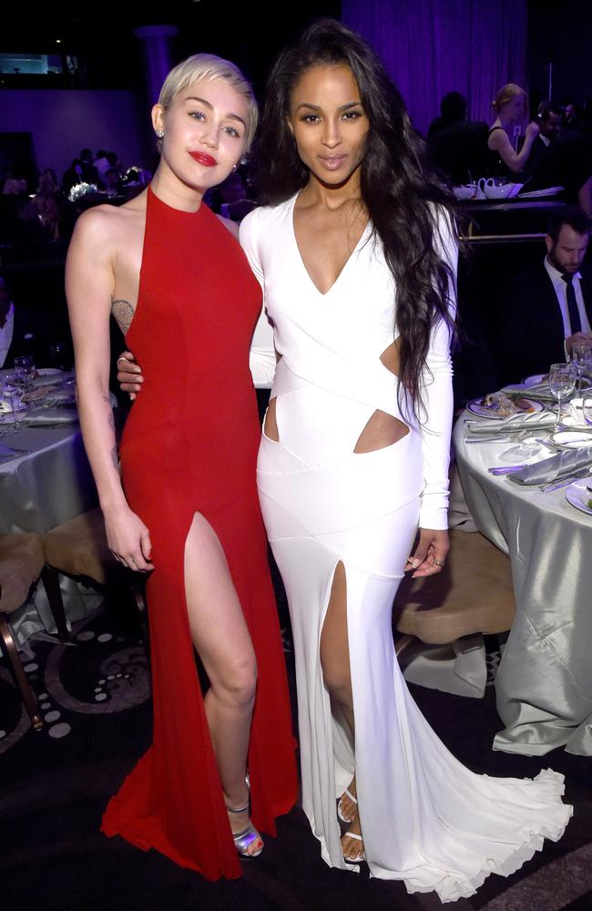 Miley Cyrus (L) with Ciara looking more demure than usual.