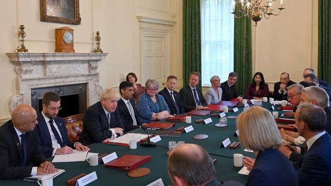 Britain's Health Secretary Sajid Javid (3rd L) and Britain's Chancellor of the Exchequer Rishi Sunak (C) listen with colleagues as Britain's Prime Minister Boris Johnson (C left) speaks at the start of a cabinet meeting in Downing Streeton July 5.