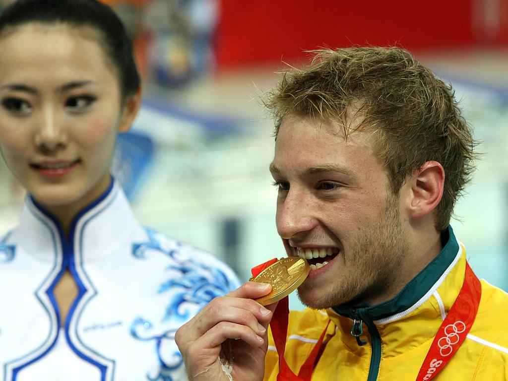 Matthew Mitcham bites his gold medal.