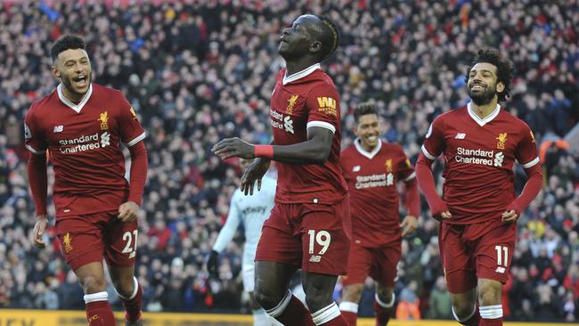 Liverpool's Sadio Mane, centre, celebrates scoring his sides fourth goal during the English Premier League soccer match between Liverpool and West Ham United at Anfield in Liverpool, England, Saturday, Feb. 24, 2018. (AP Photo/Rui Vieira)