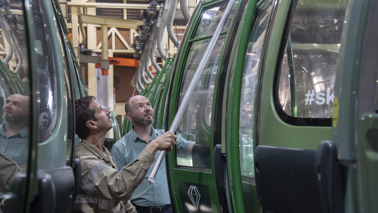 Richard Berman-Hardman, general manager of far north Queensland’s Skyrail tourist cableway is pessimistic about survival following the coronavirus. He is pictured in the goindoia storage facility closing the doors with gondola technician Adam Cowan (left). Picture: Brian Cassey