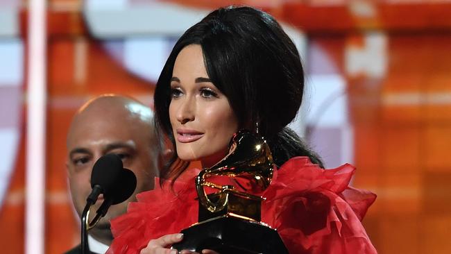 Kacey Musgraves accepts ne of her swag of awards. Picture: Robyn Beck/AFP