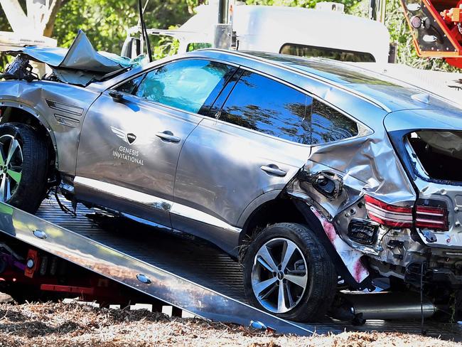 A tow truck recovers the vehicle driven by golfer Tiger Woods in Rancho Palos Verdes, California, on February 23, 2021, after a rollover accident. - Woods was hospitalized Tuesday after a car crash in which his vehicle sustained "major damage," the Los Angeles County Sheriff's department said. Woods, the sole occupant, was removed from the wreckage by firefighters and paramedics, and suffered "multiple leg injuries," his agent said in a statement to US media. (Photo by Frederic J. BROWN / AFP)