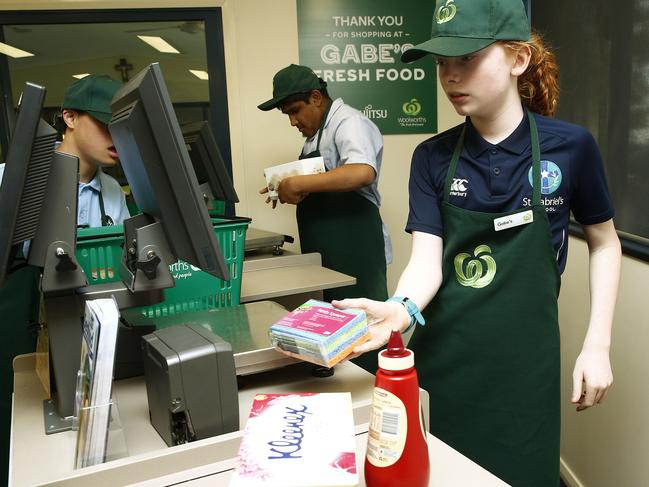 James Garland, 13, using the scanner at the checkout. Picture: John Appleyard