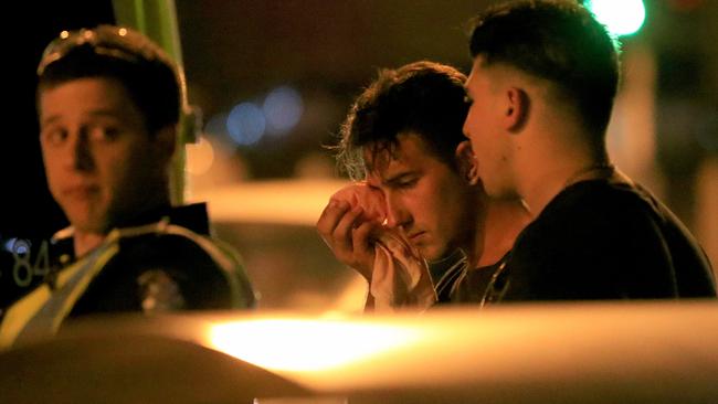 A man holds an ice pack to his face after violence erupted. Picture: Mark Stewart