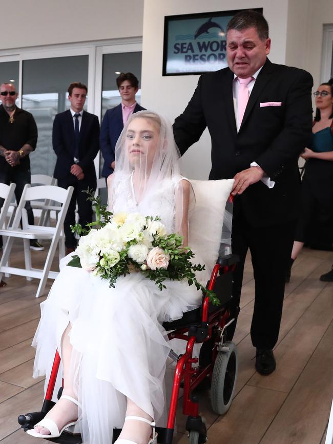 Tony Simrajh wheeling his daughter Ashleigh down the aisle on her wedding day in September. The melanoma campaigner passed away 11 days later. Photo: Jason O'Brien