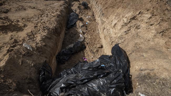 Bodies lie in a mass grave in Bucha, Ukraine. The Ukrainian government has accused Russian forces of committing a "deliberate massacre" as they occupied and eventually retreated from Bucha, 25km northwest of Kyiv. Picture: Getty